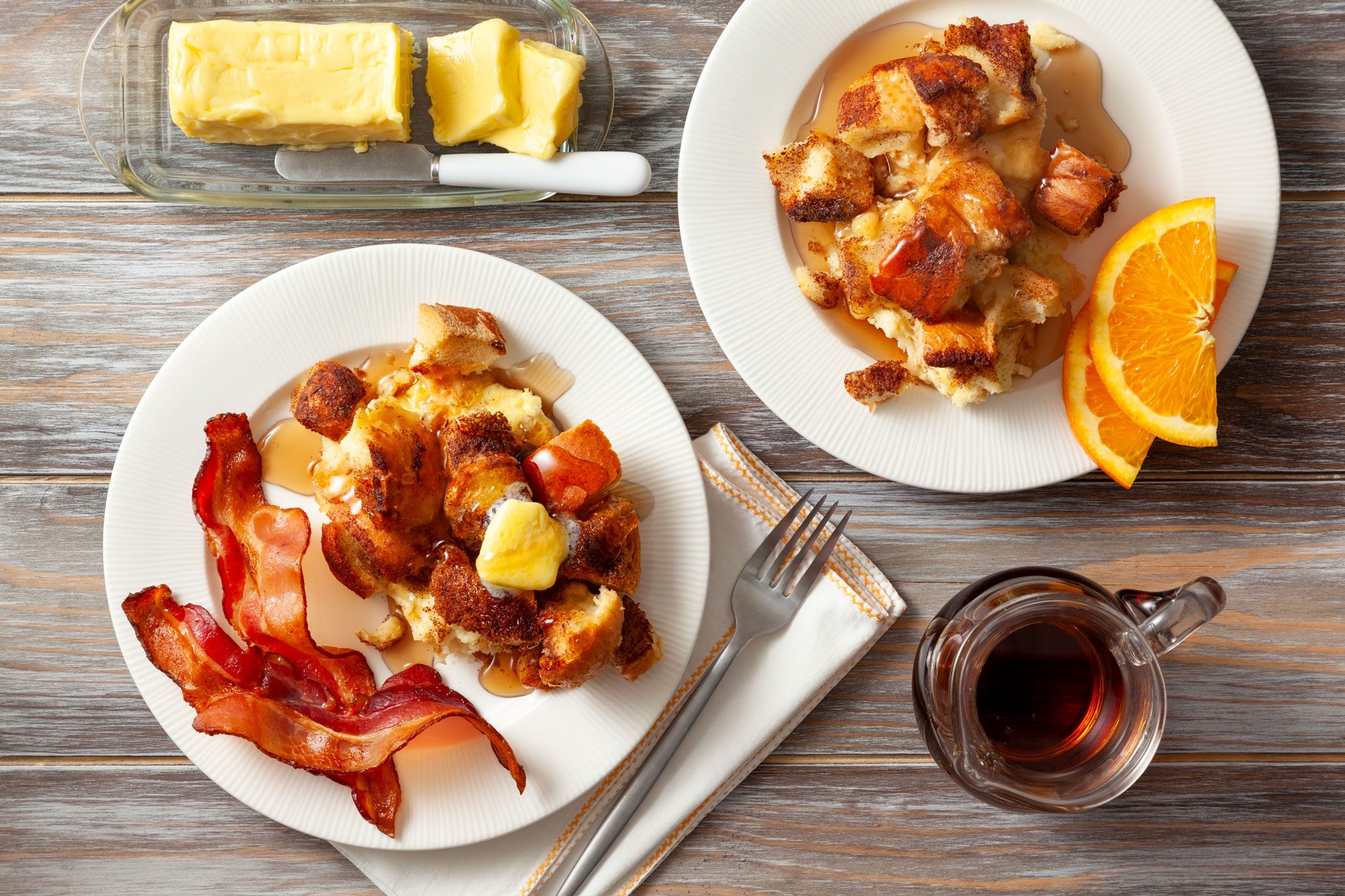 Two plates of French Toast Casserole on a table with a fork