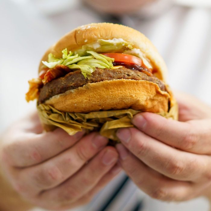 A man eating cheeseburger.