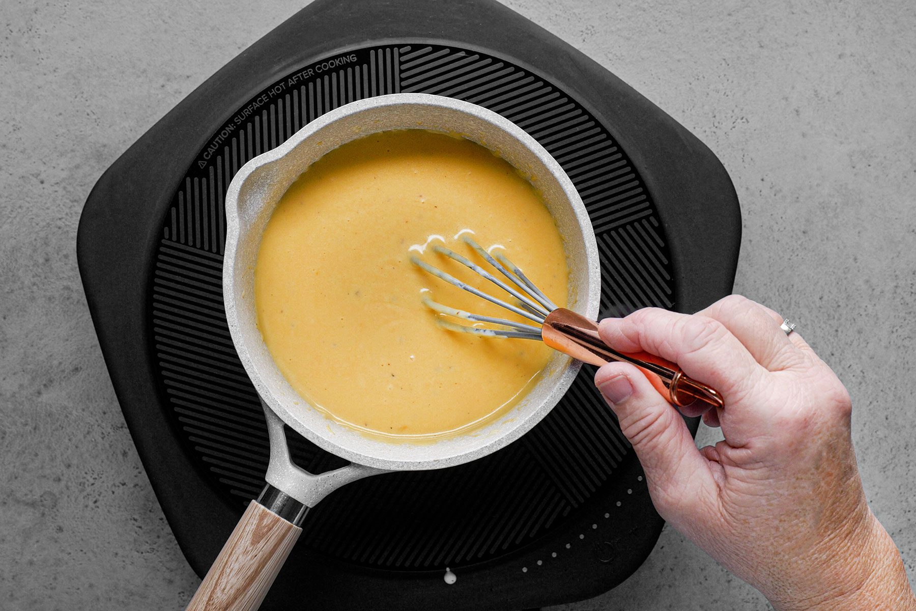 Mixing cheddar cheese in mixture