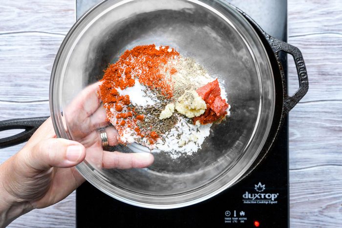Flour, paprika, tomato paste combined in a large bowl