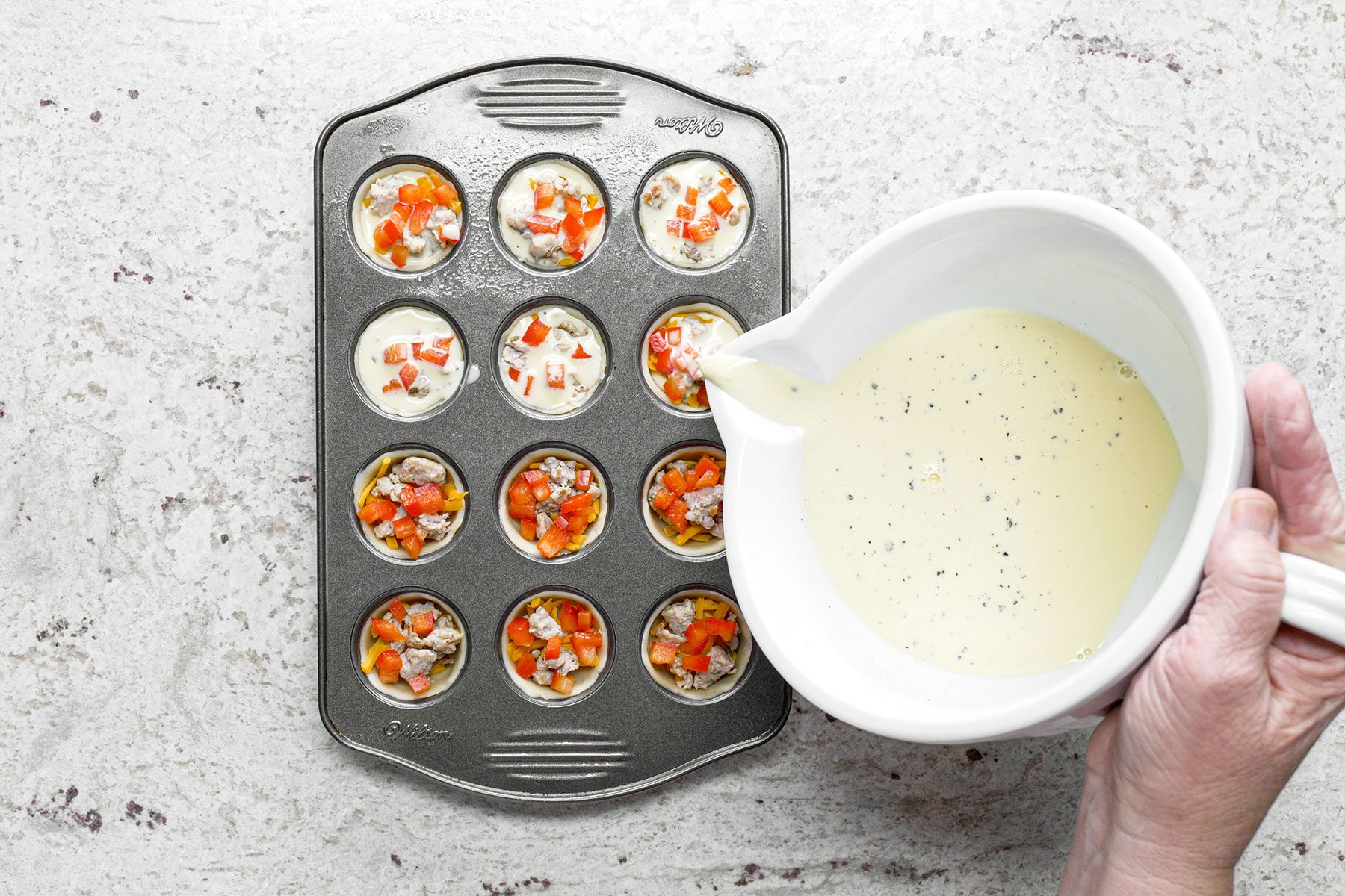 Adding egg mixture in Mini Quiches