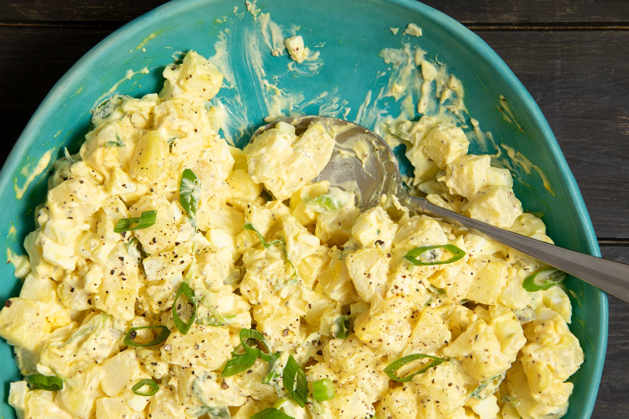 A bowl of Southern Potato Salad topped with green onion