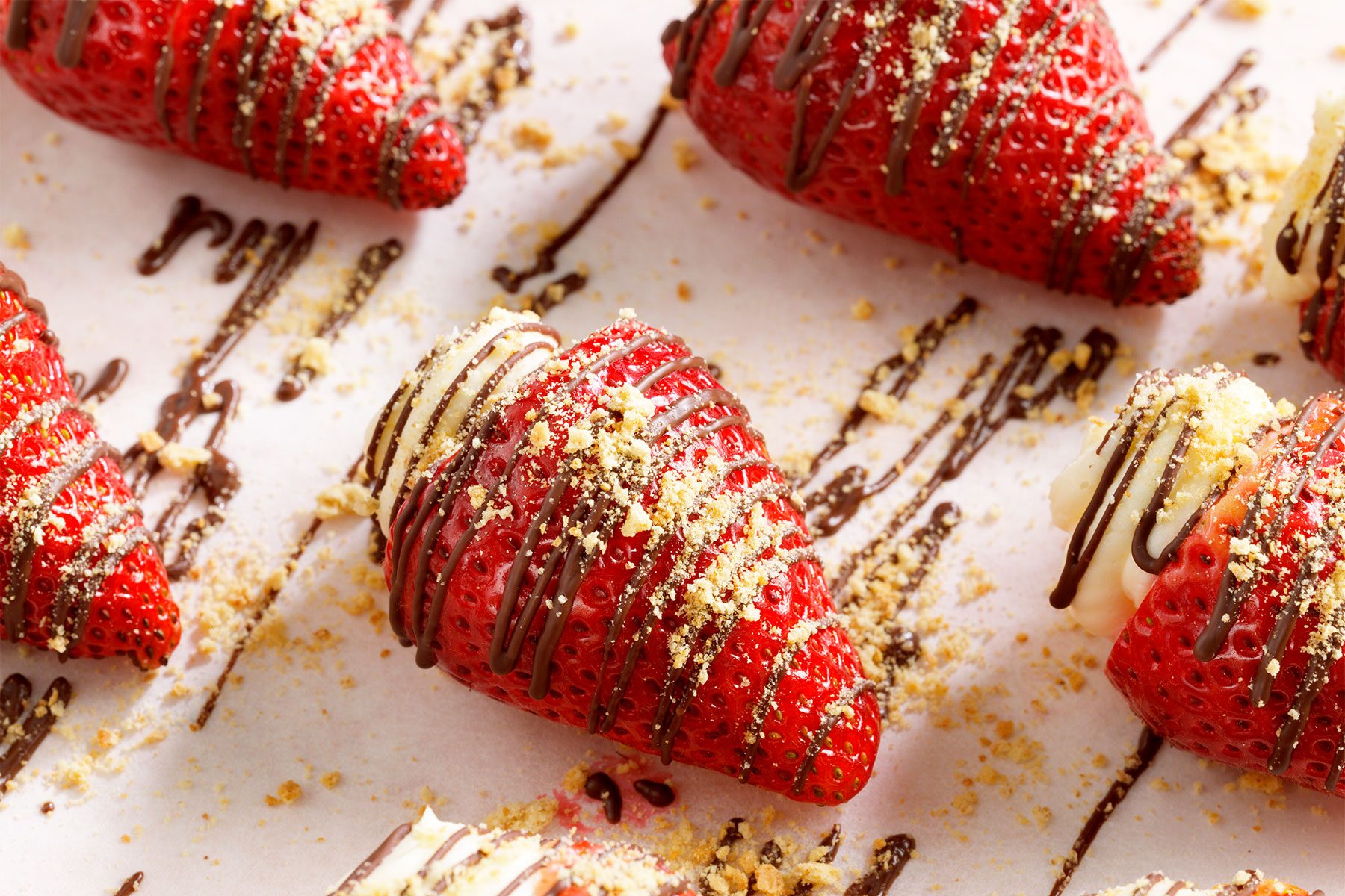 Overhead shot of Strawberry Cheesecake Bites with drizzled chocolate