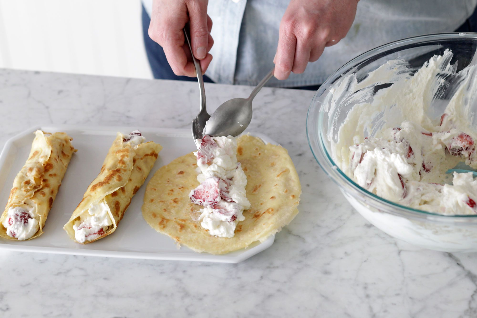 Spoon filling down the center of each crepe, and gently roll up