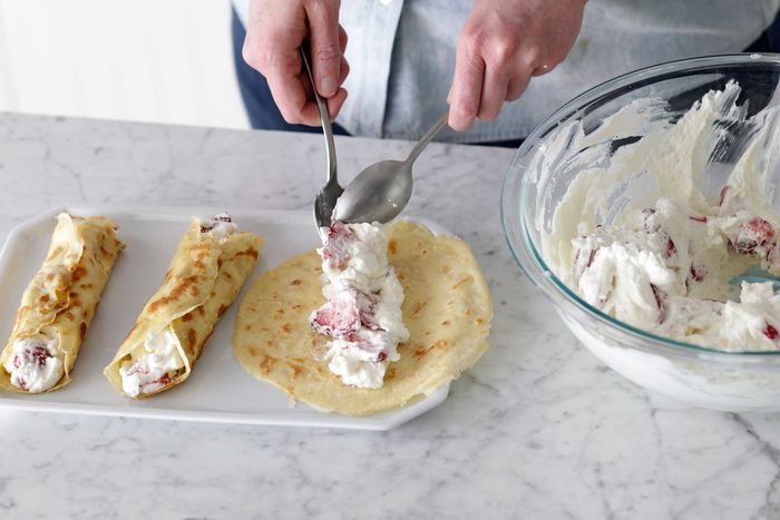 Spoon filling down the center of each crepe, and gently roll up