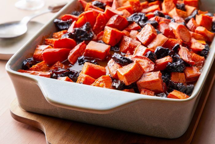 Tzimmes dish served in a baking pan on a wooden table