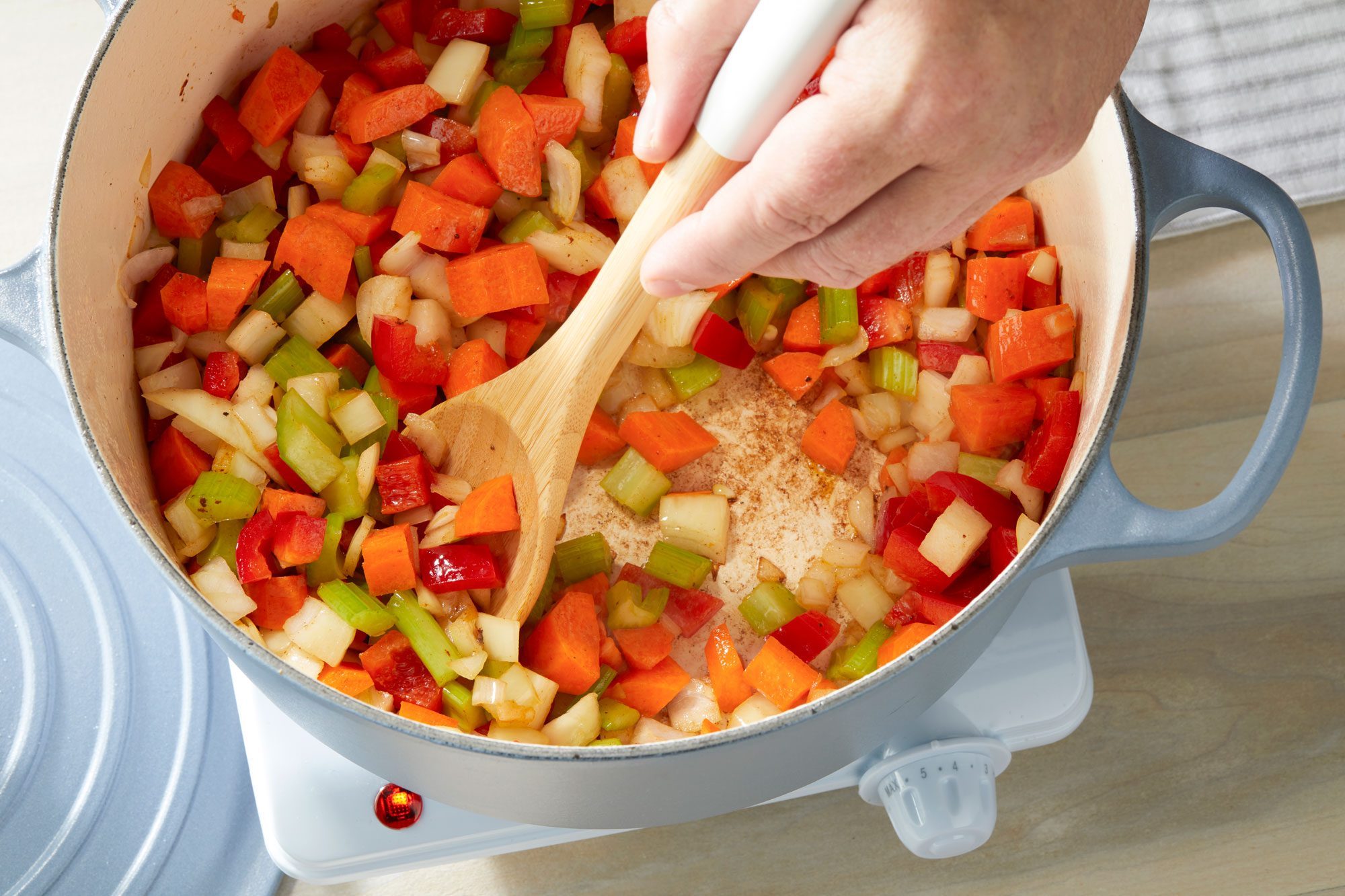 Cooking celery carrots onion red bell pepper & garlic until tender