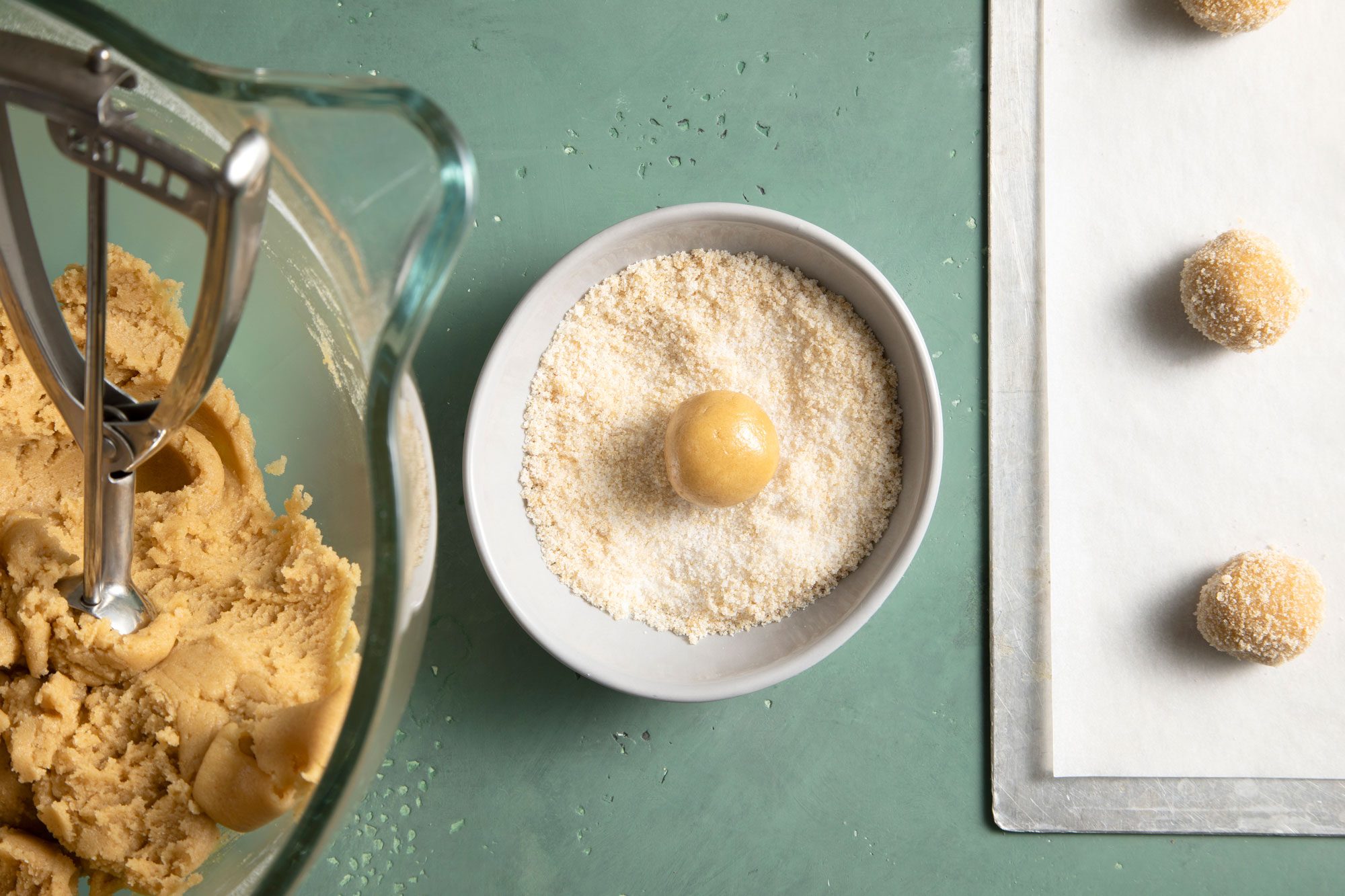 Toss the cookie dough balls in the sugar mixture until they’re fully coated