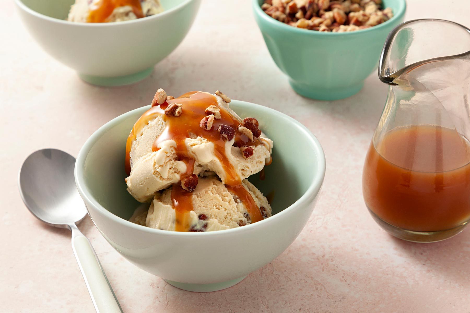 close shot of butter pecan ice cream with caramel sauce