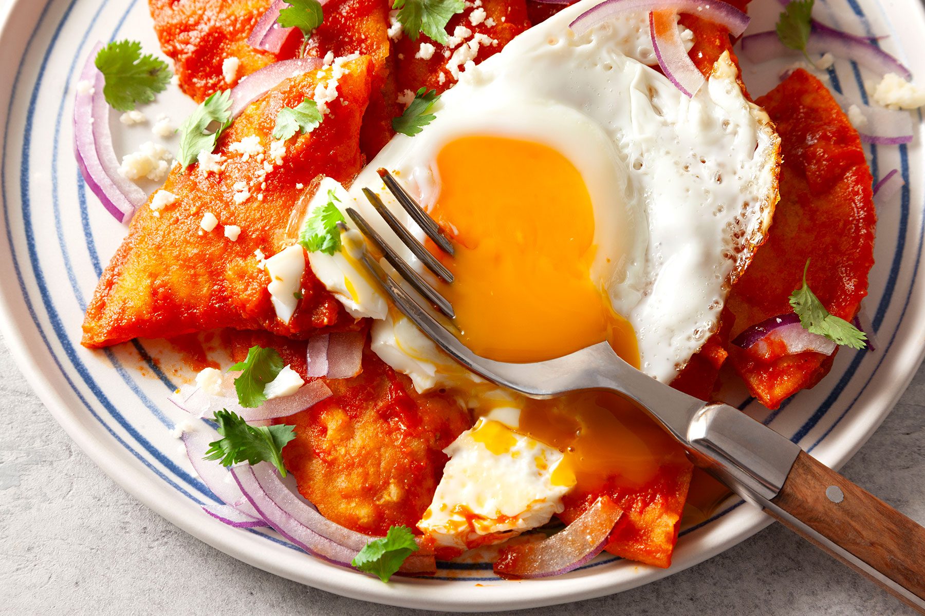 Chilaquiles served on plate with fork