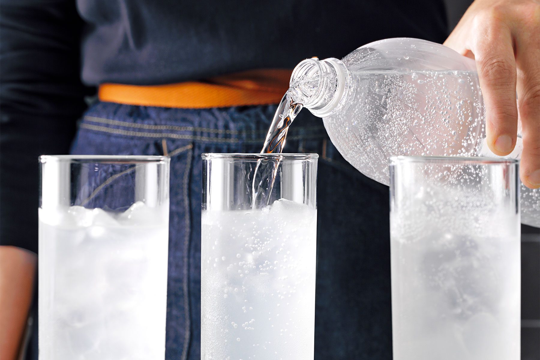 Table view shot of top with a splash of club soda; soda bottle;