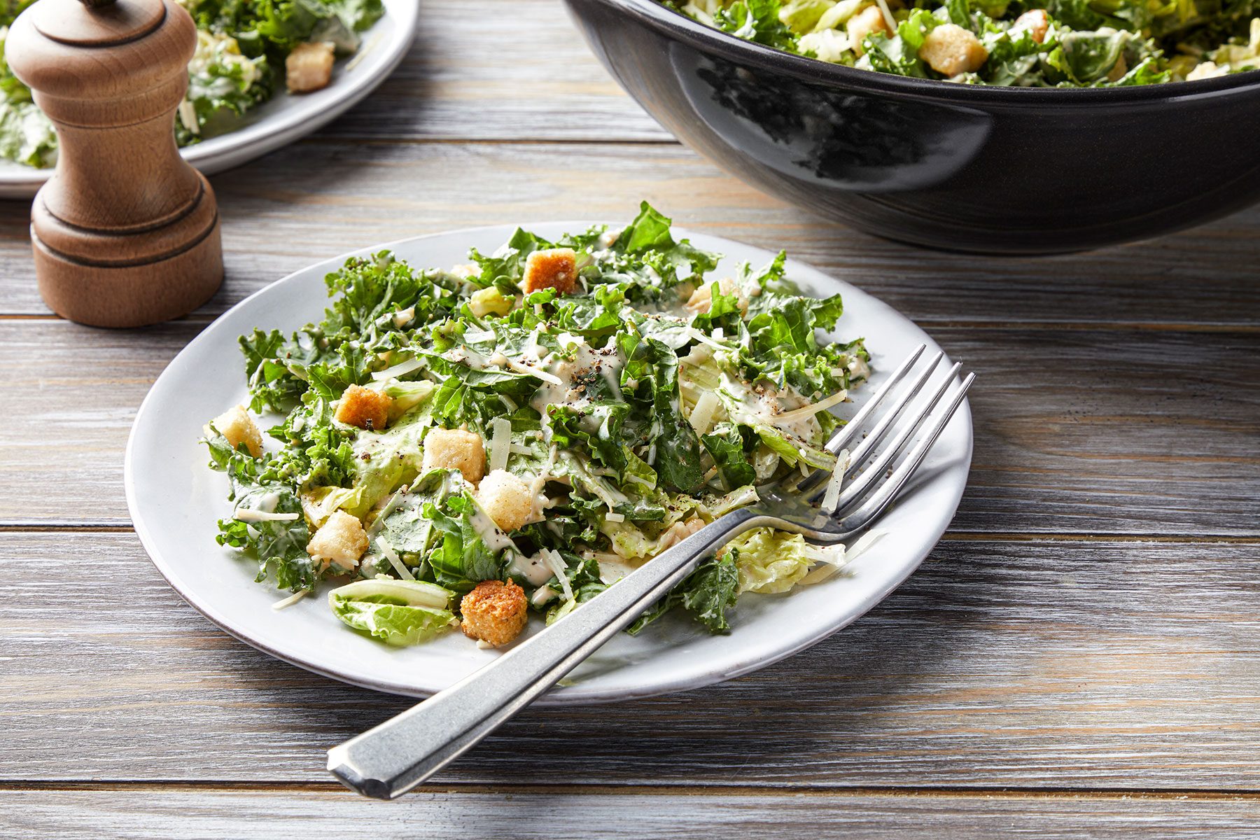 Kale Caesar Salad served on white plate with fork