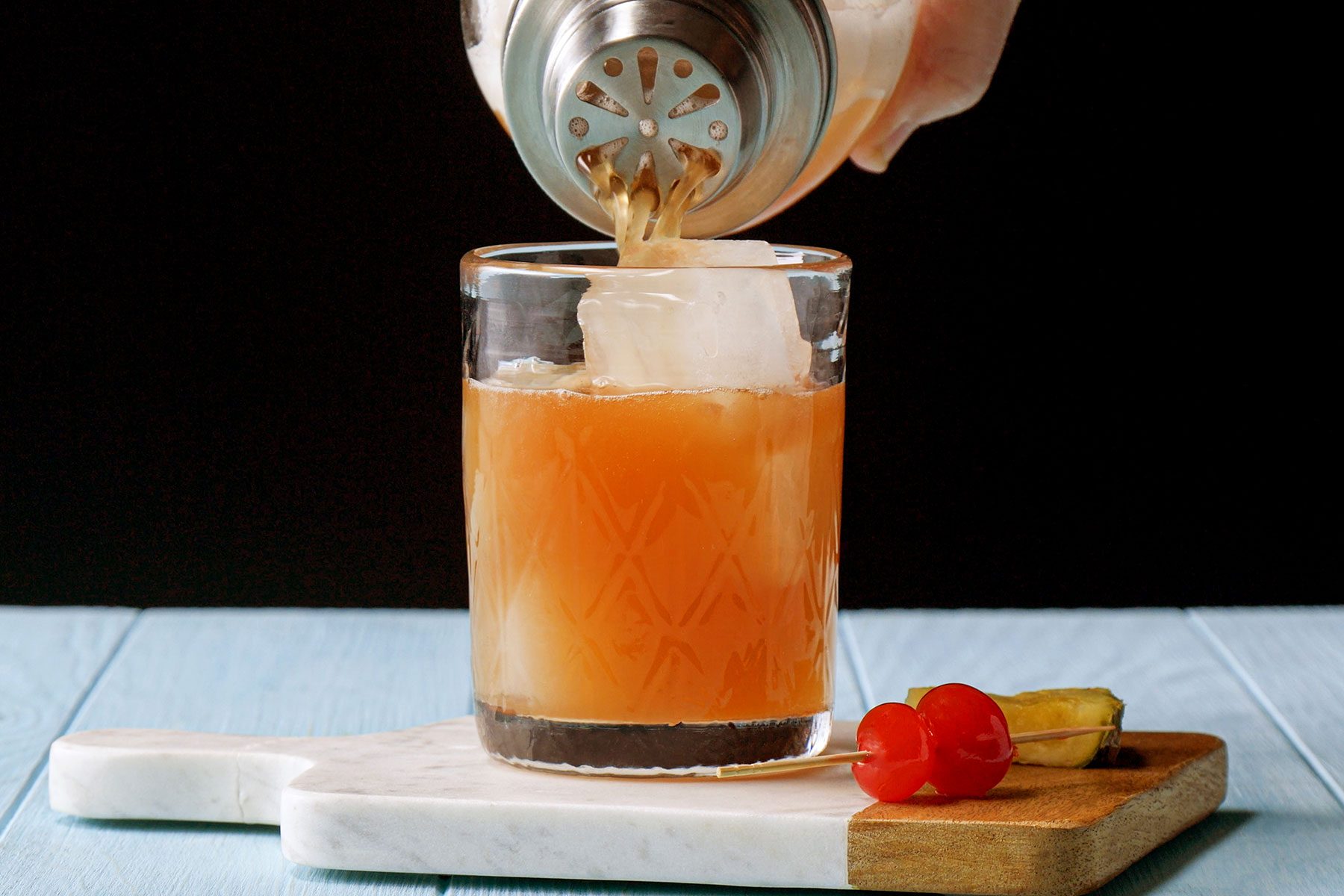 Filling the glass with cocktail