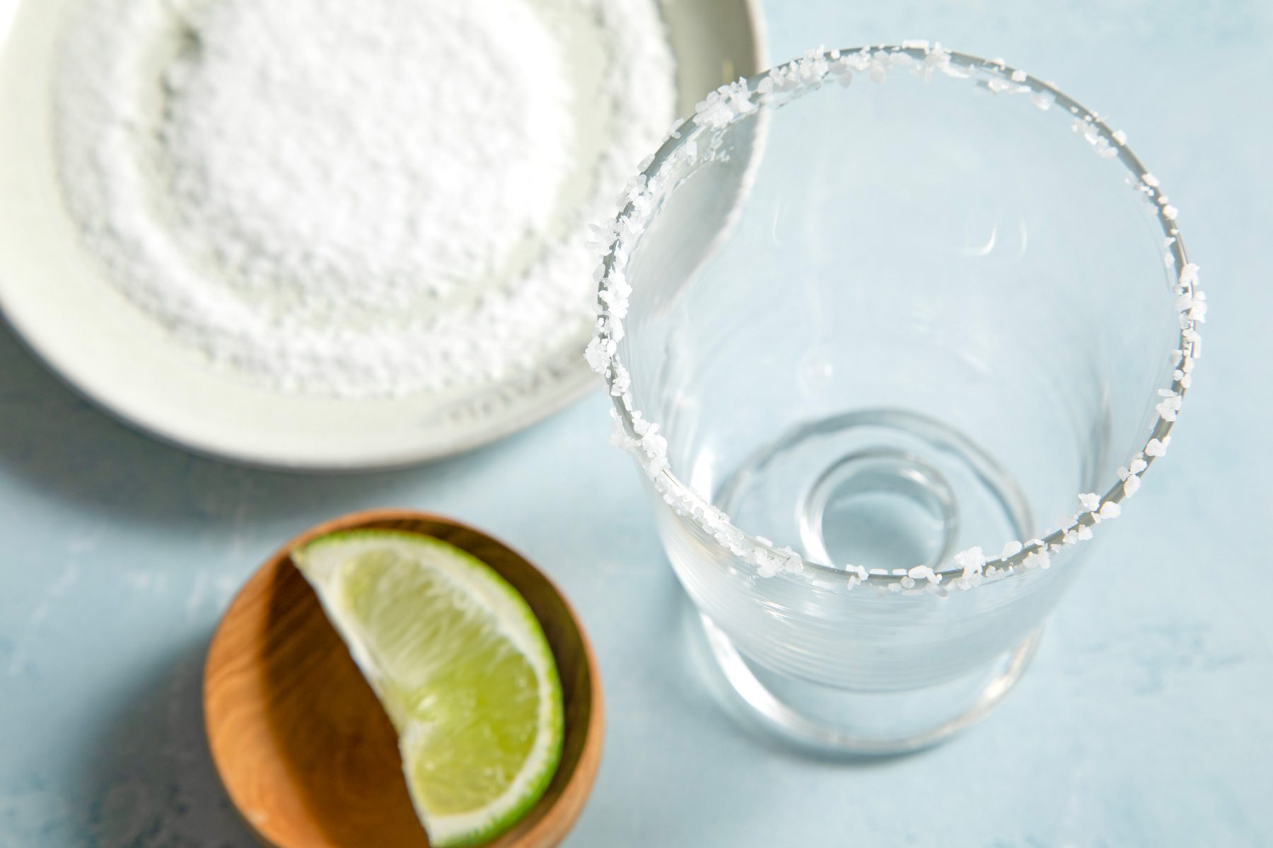 A salt-rimmed glass with a wedge of lemon