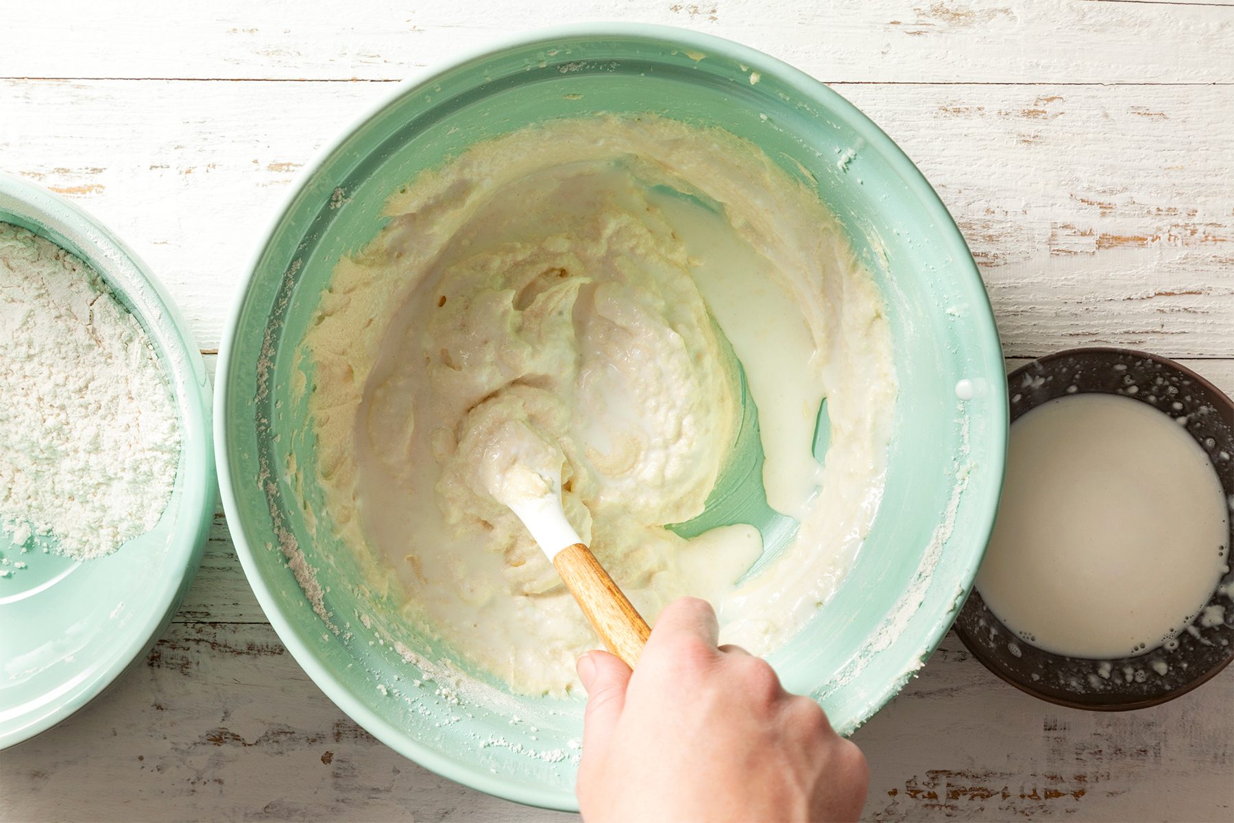 A person mixing ingredients in a bowl