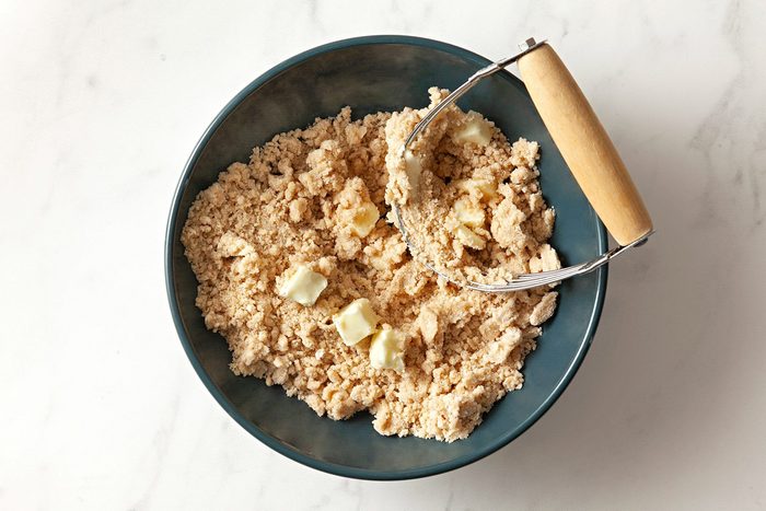 overhead shot; white background; In a bowl, combine salt, sugar and flour and cut in butter