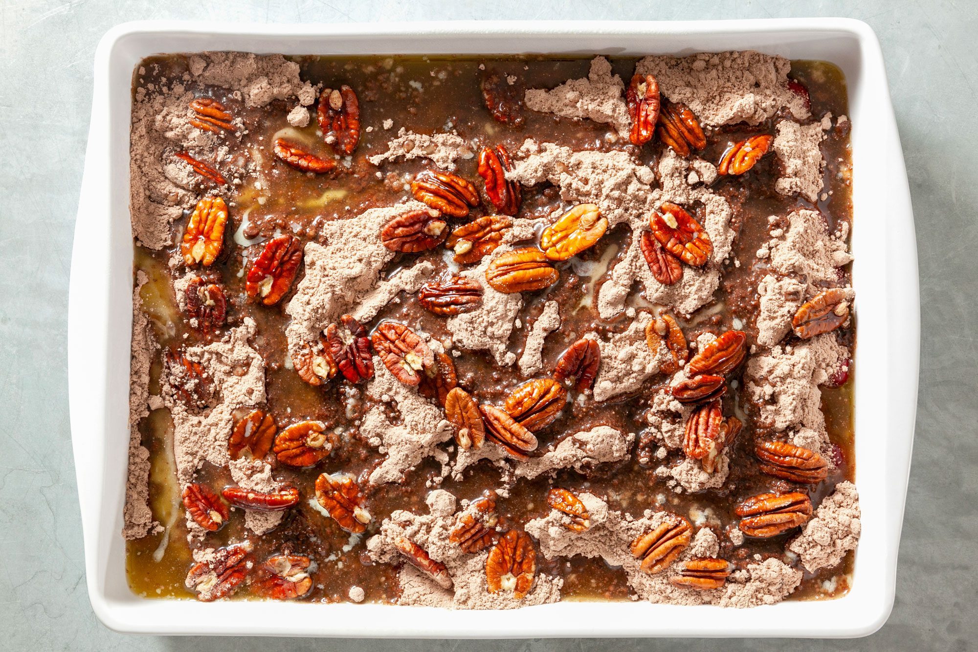 Overhead shot of melted butter poured over cake mix