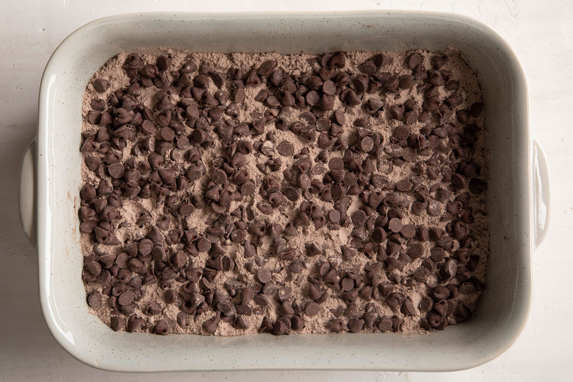 chocolate chips and dry cake mix in a rectangular baking dish