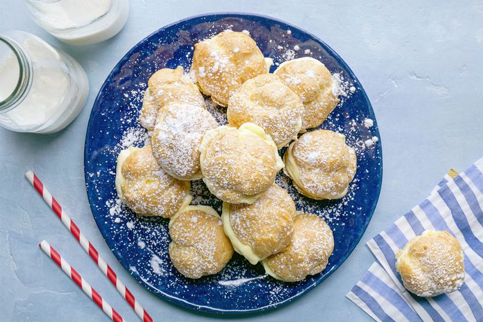 overhead shot of mini cream puffs served with milk