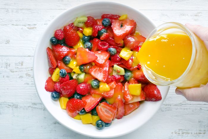 overhead shot of fruit salad dressing served over fruits