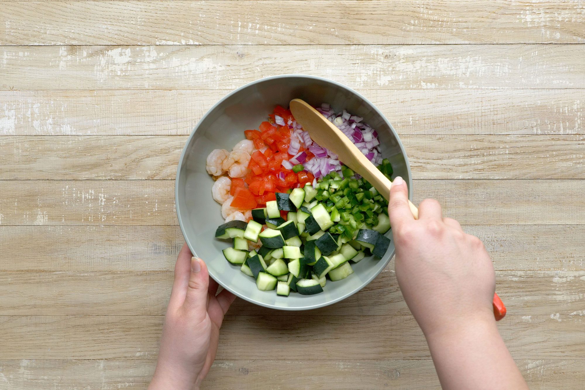 Toss the shrimp, tomatoes, cucumber, red onion and jalapeno in a large bowl