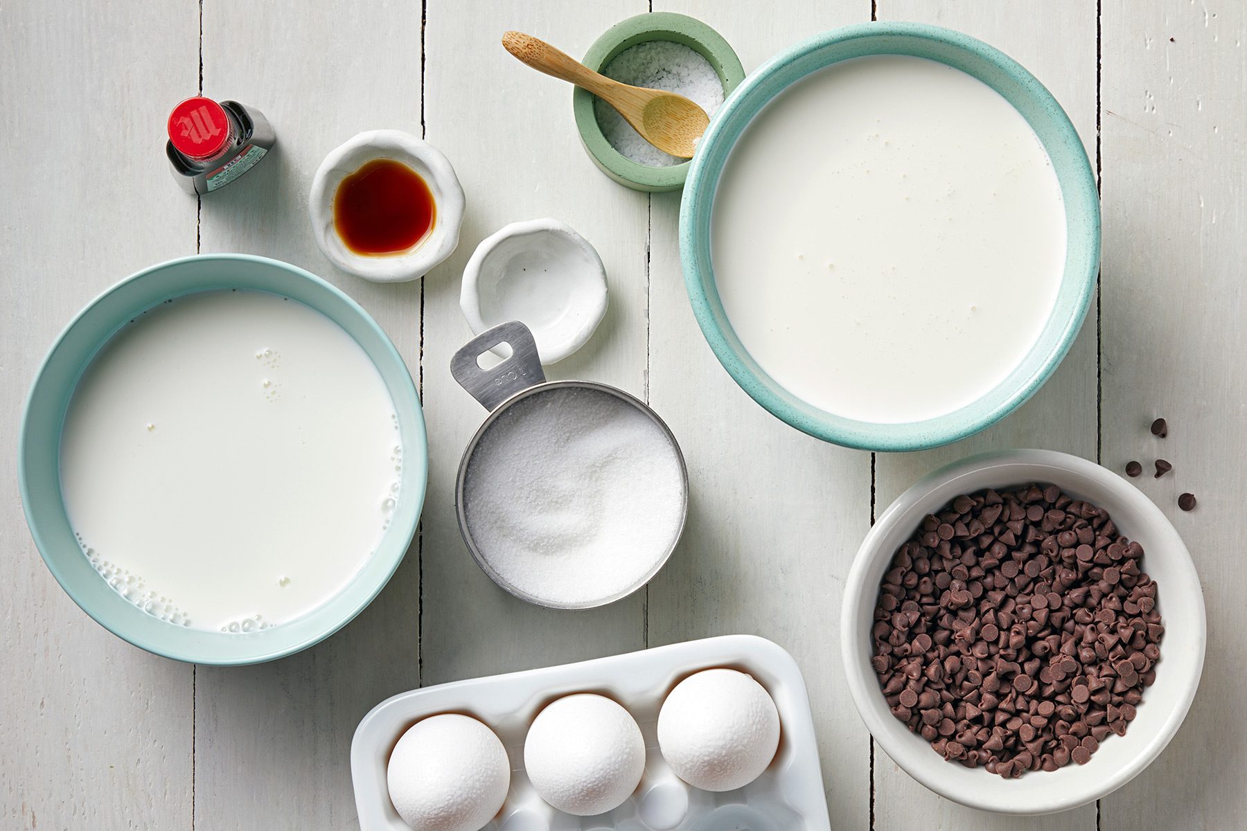 overhead shot; white background; Mint Chocolate Chip Ice Cream ingredients placed over background;