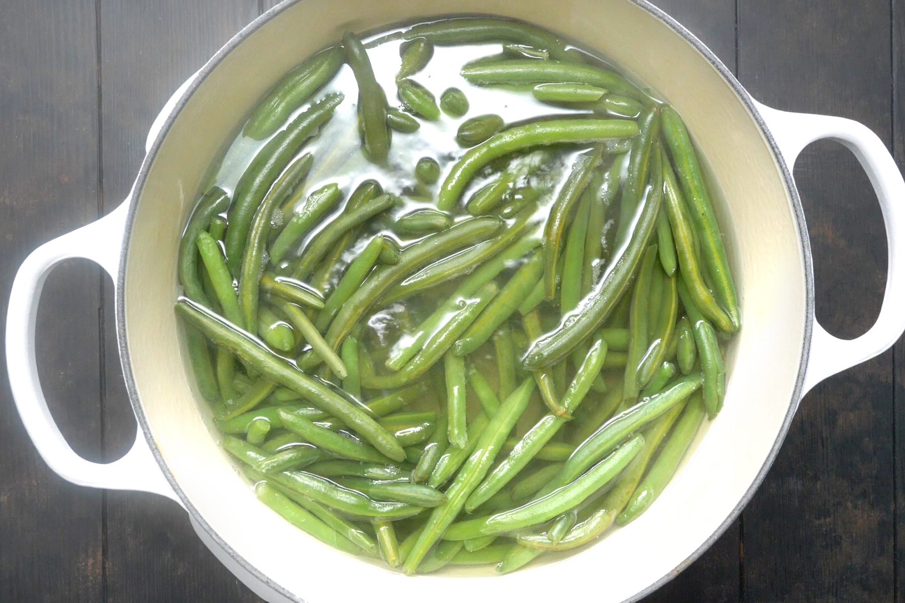 Green Beans boiling in water in a Dutch oven