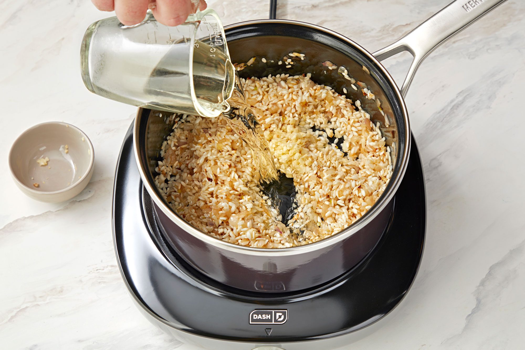 pouring wine into a saucepan