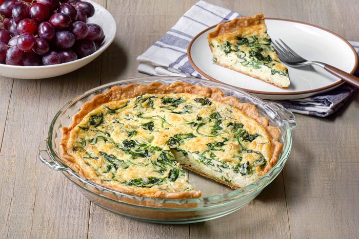 A savory Gruyere Spinach Quiche featuring cheese served
