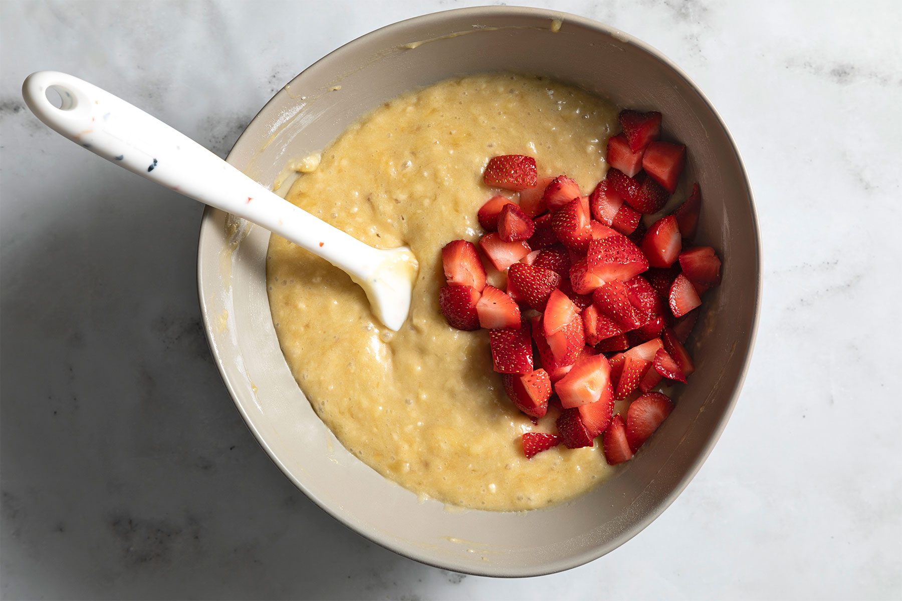 overhead shot of chopped strawberries mixed in flour mixture