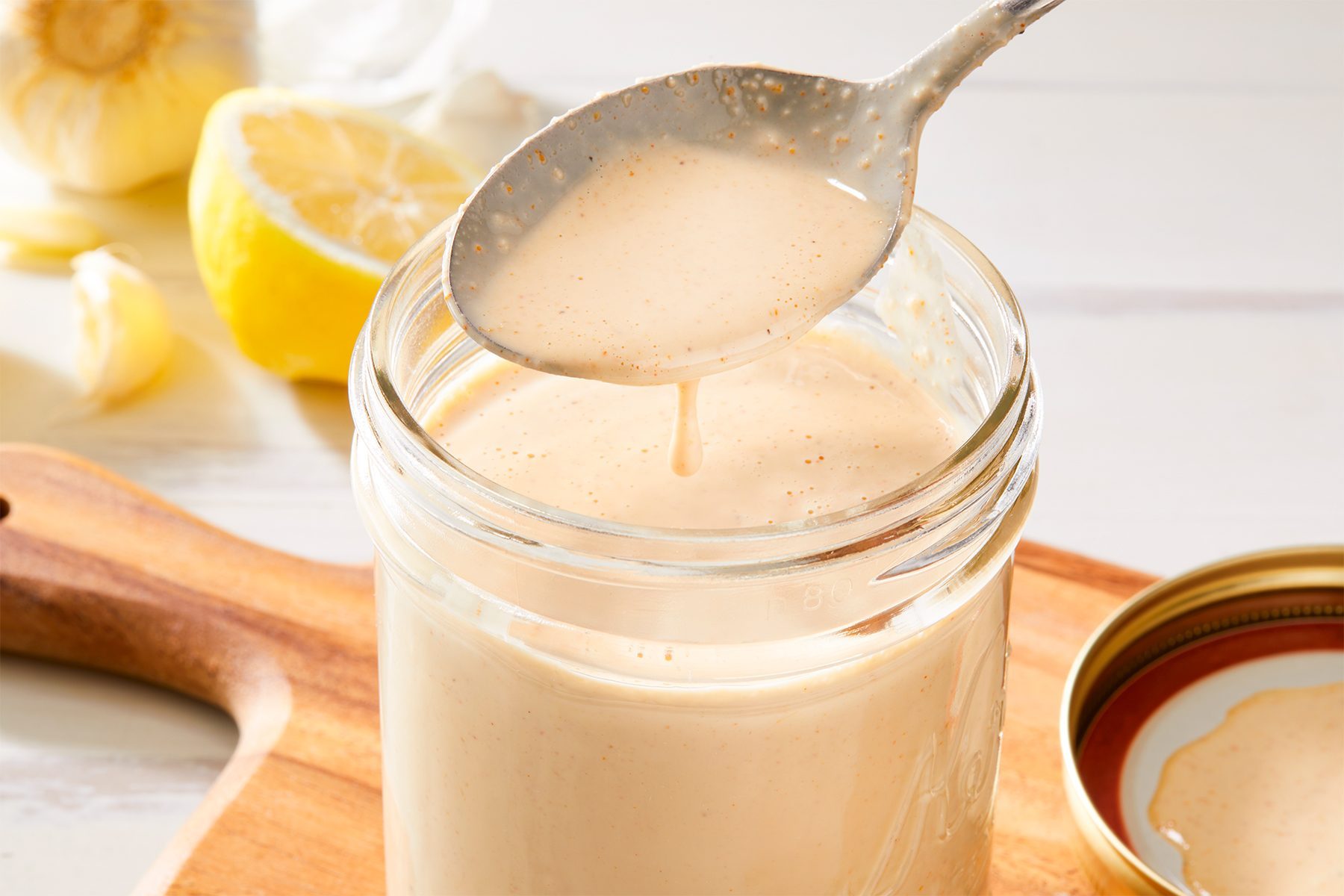 close shot of tahini dressing in a jar