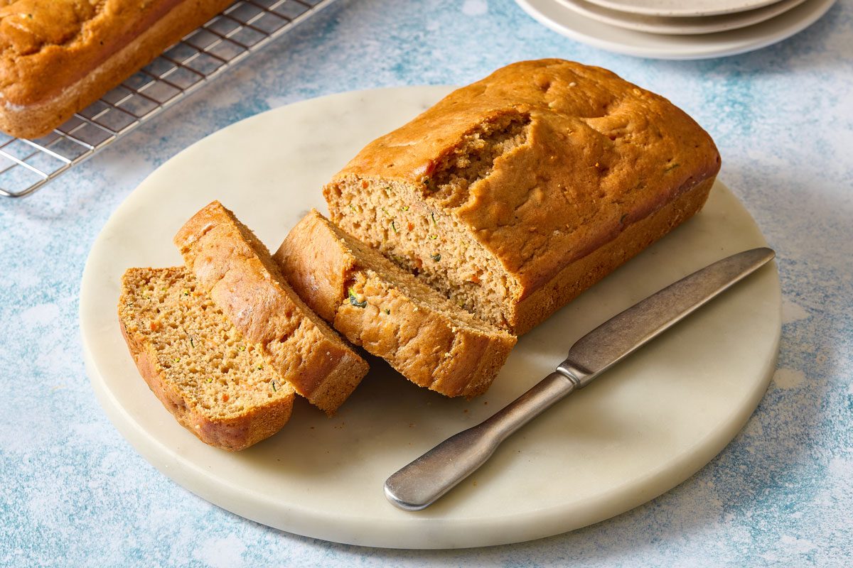 Slices Of Zucchini Carrot Bread Served On A Plate With Knife