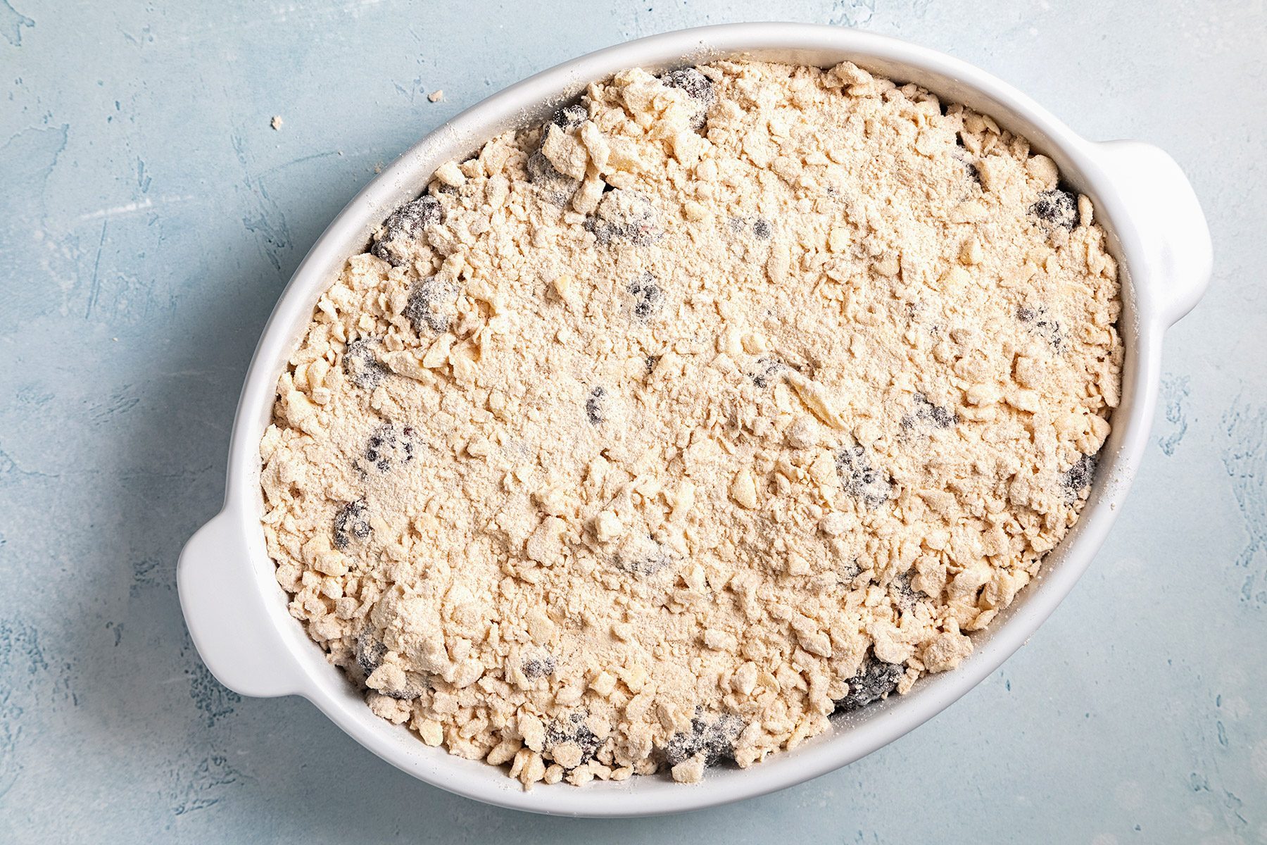Overhead shot of baking dish; bake until filling is bubbly and topping is lightly browned; blue marble background