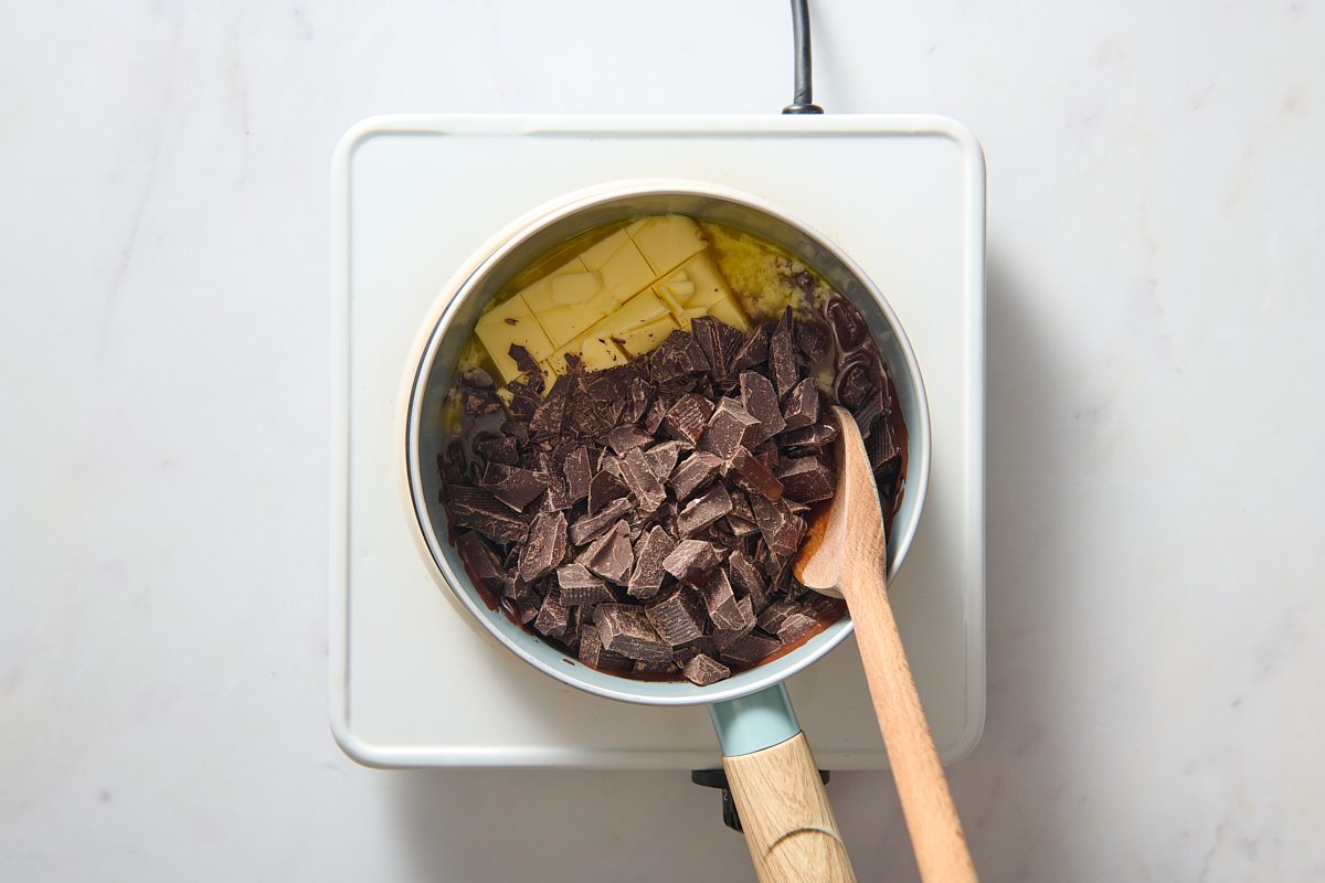 Chocolate and butter being melted in a small pan