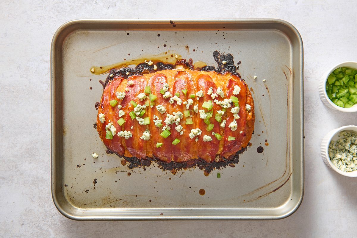 Buffalo Chicken Meatloaf once baked and topped with blue cheese and celery