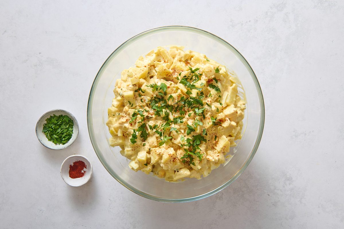 Finished potato salad topped with paprika and parsley