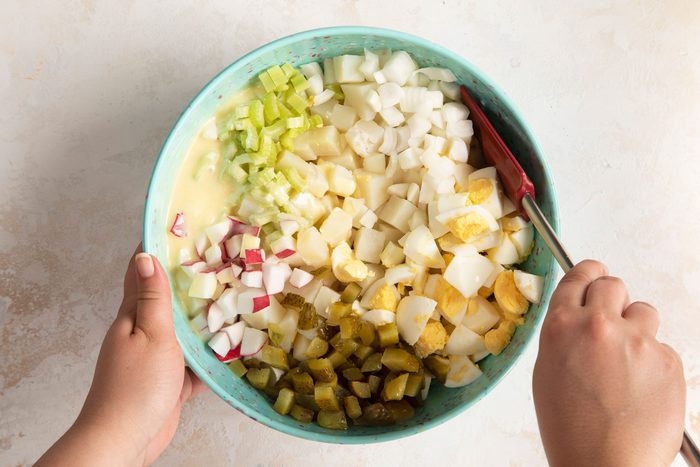 Stir carefully to coat the ingredients without smashing the potatoes and eggs