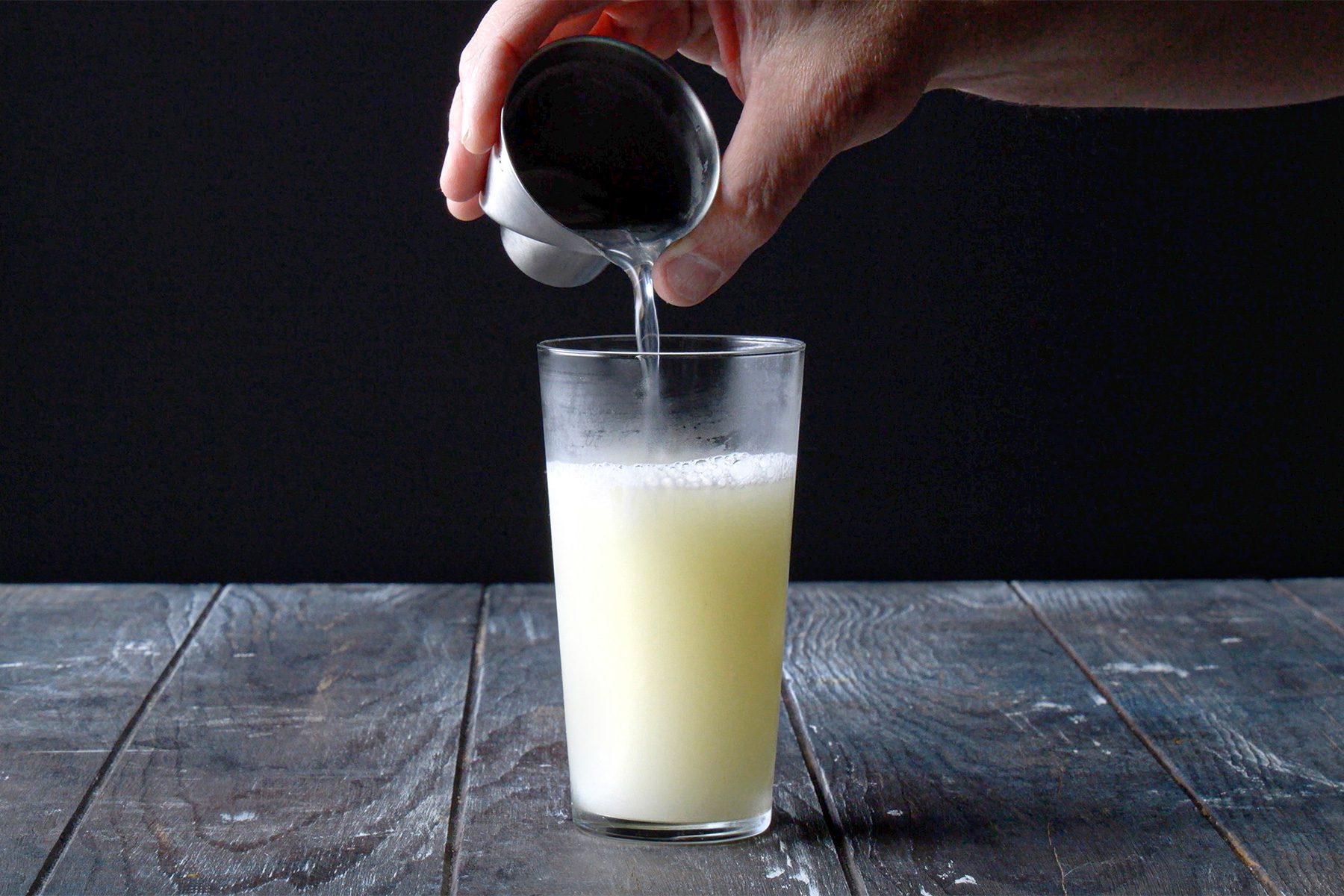 horizontal shot; black background; adding club soda