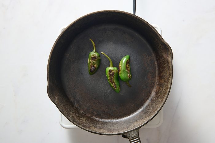 Blistering jalapeños in a skillet