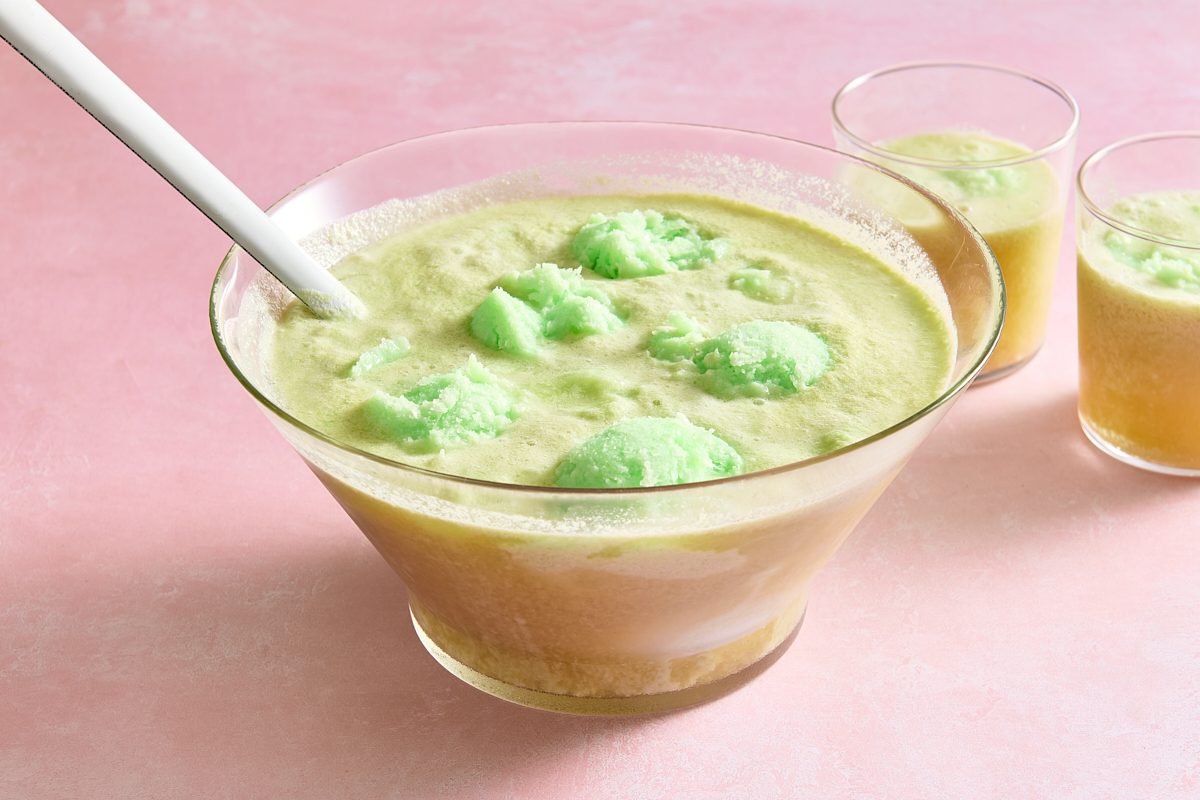 Lime sherbet punch in a punch bowl with a ladle