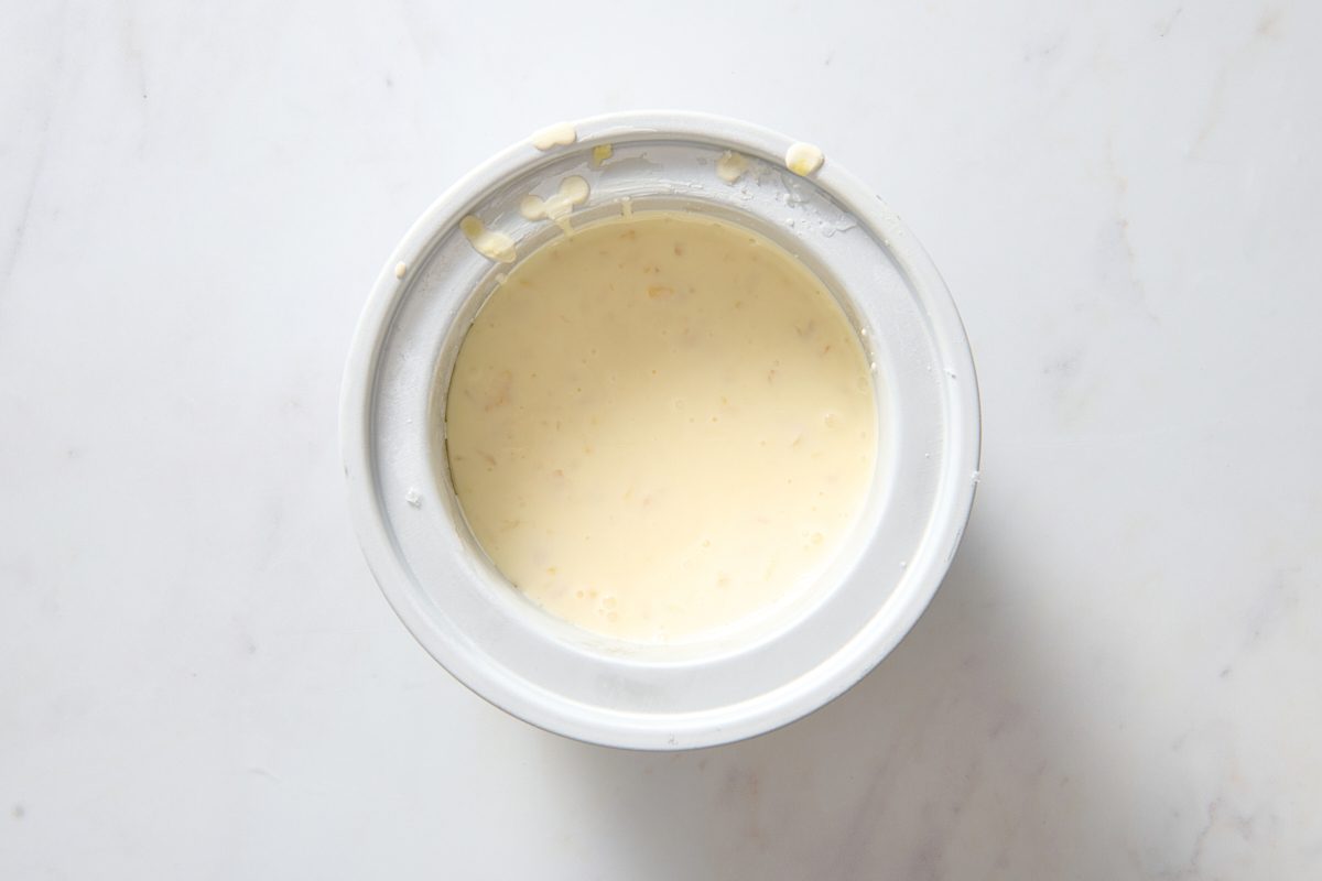 Pineapple ice cream added to an ice cream maker