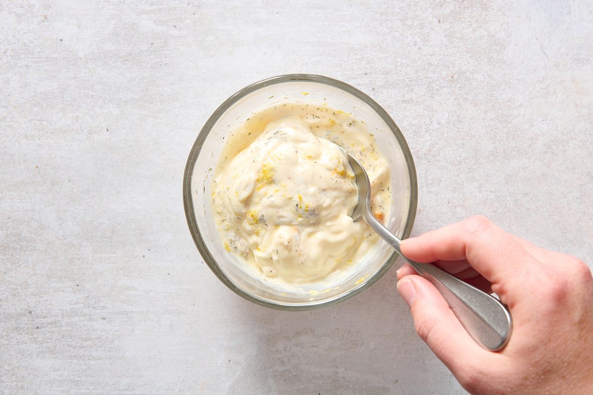 Mixing salmon patty sauce ingredients in a bowl