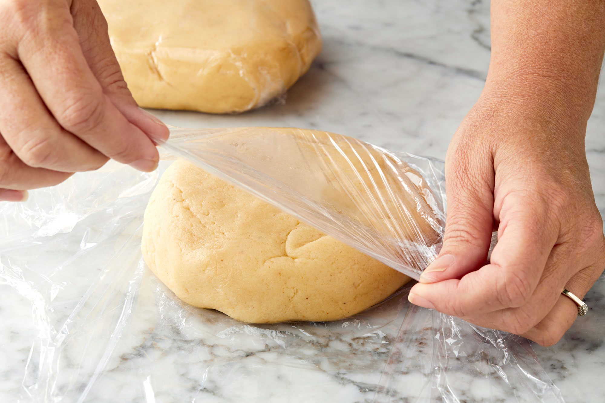Divide dough in half. Shape each into a disk and wrap in plastic.