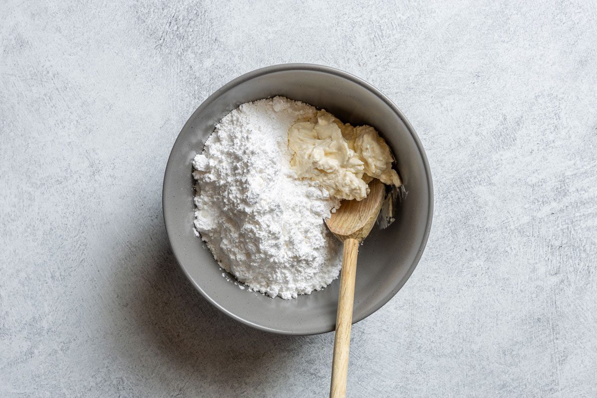 Mixing Cream Cheese And Butter And Milk And Vanilla Extract for Zucchini Cake frosting