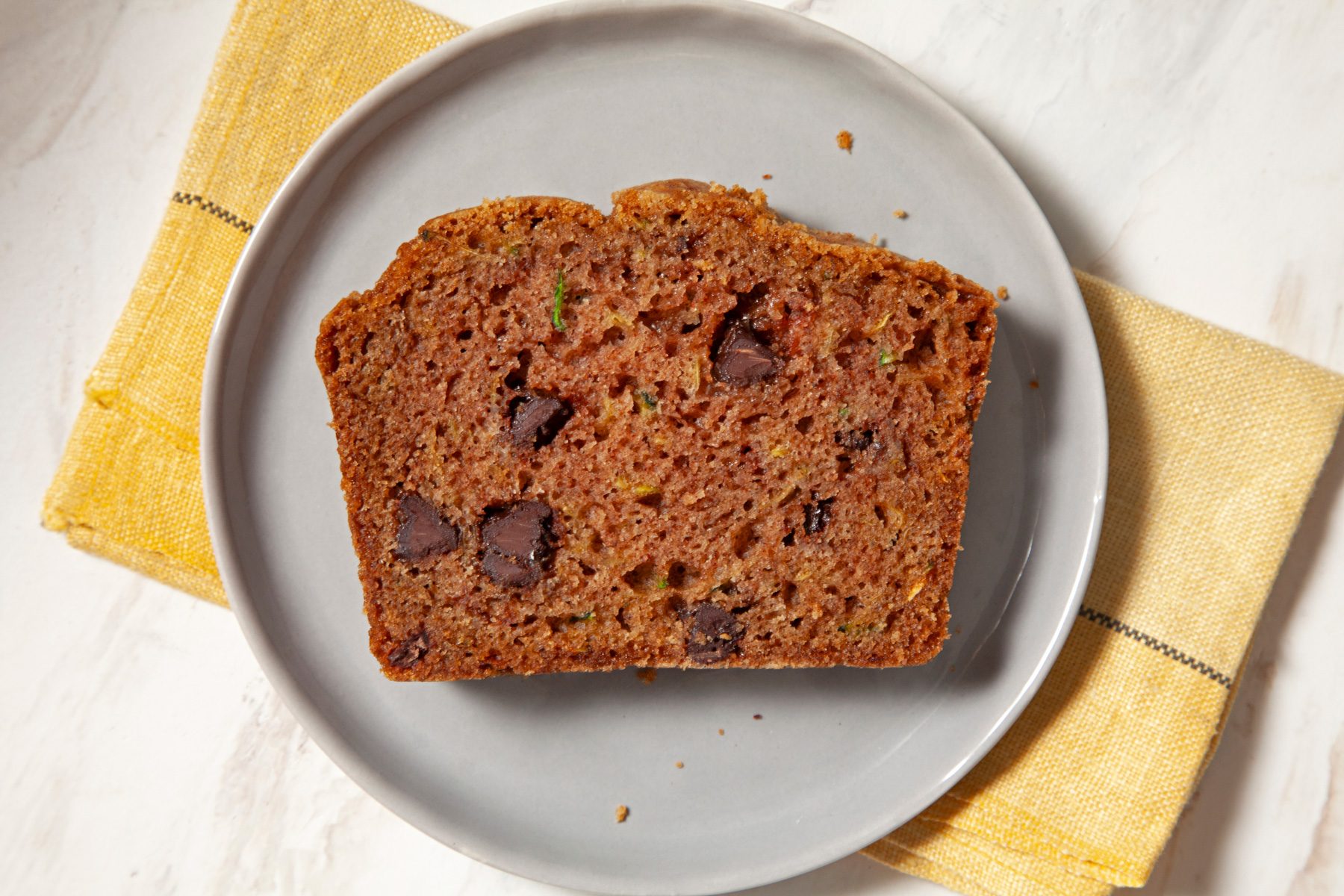 A plate of Zucchini Chip Loaves on a marble counter