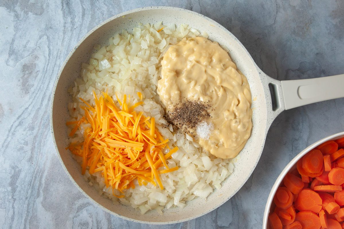Step 2 of Taste of Home Carrot Casserole is browning onions and adding cream of celery soup, cheddar cheese and seasonings into the pan