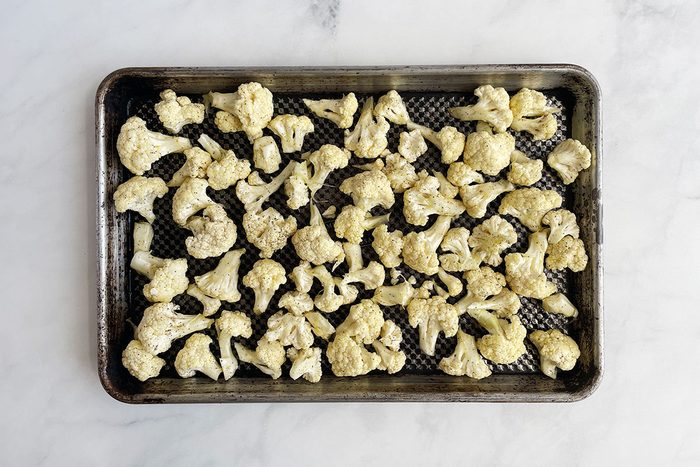 How to make Taste of Home's Cauliflower Gratin, step 1: roasting cauliflower on a baking sheet