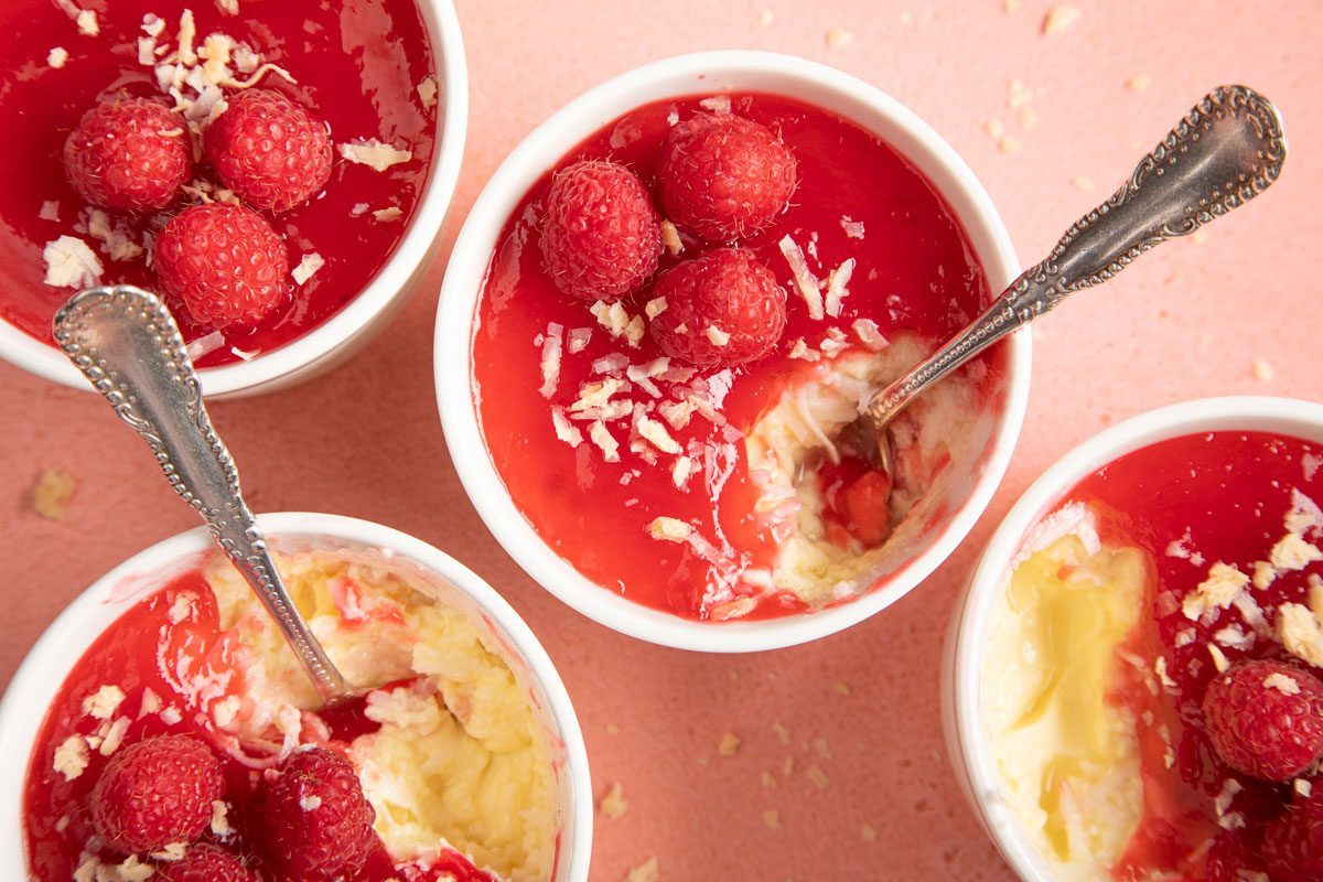 Coconut Custard topped with raspberry in small ramekin dishes