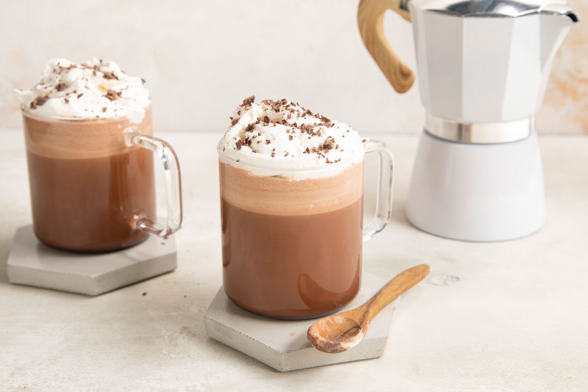 Hot Chocolate Coffee in a clear mug topped with whipped cream
