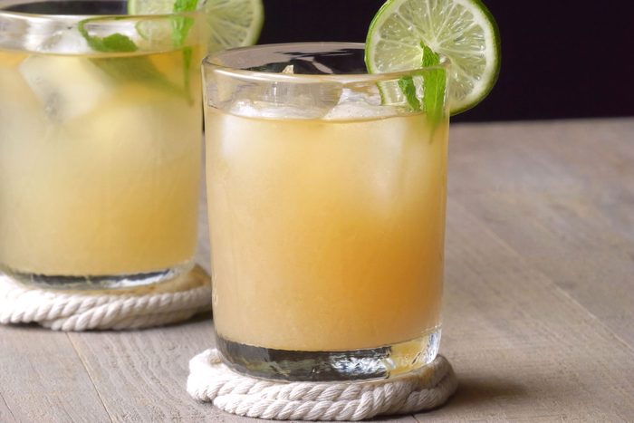 Mai Tai served into double rocks glass garnished with lemon and mint leaves